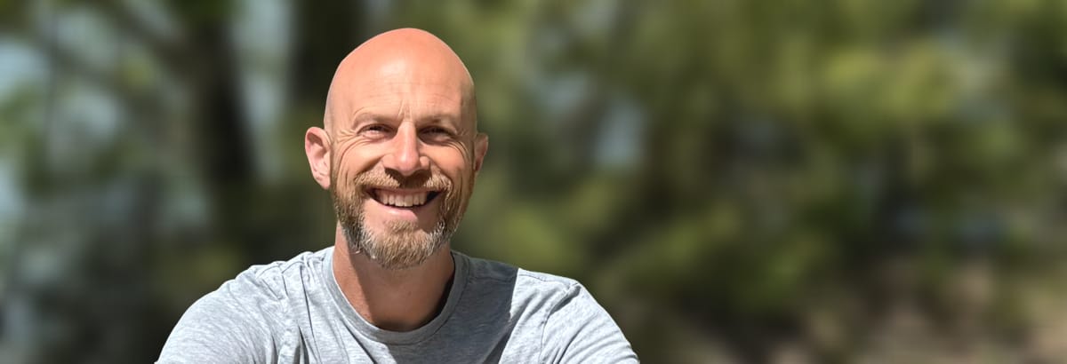 Joel Zaslofsky rectangular head shot with trees